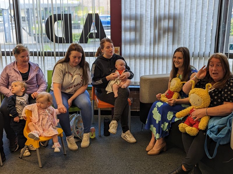 Families welcome a special visitor to Bookbug session in Erskine
